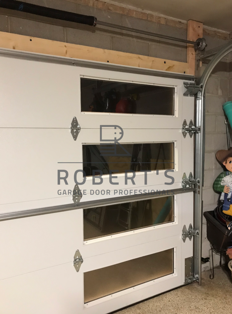 DEANS OLD WOOD GARAGE DOOR AFTER FRAMING, PAINTING AND REPLACEMENT WITH