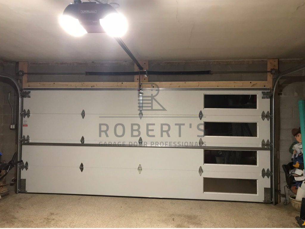 DEANS OLD WOOD GARAGE DOOR AFTER FRAMING, PAINTING AND REPLACEMENT WITH