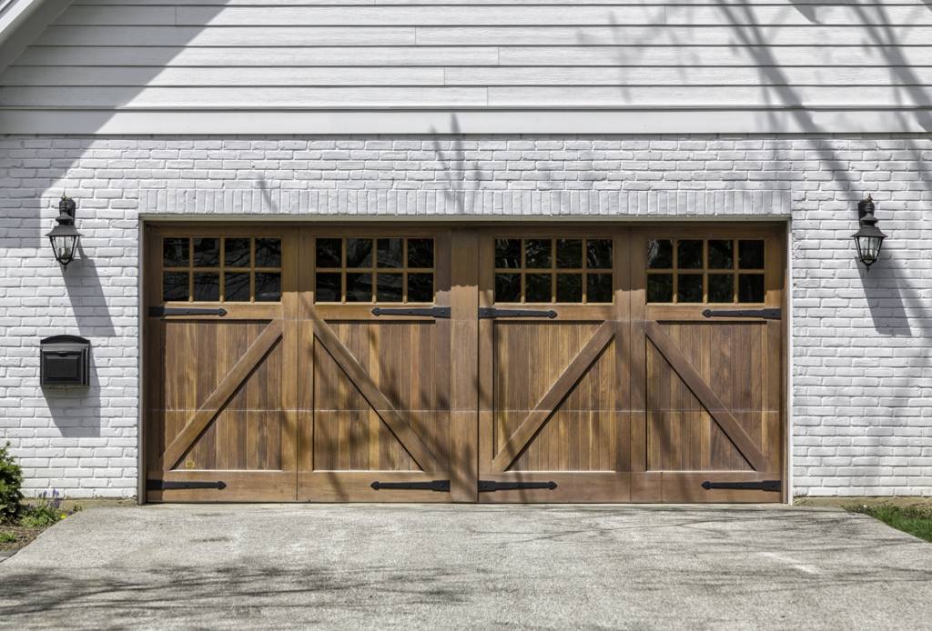 A gray brick, 2-car residential garage with double wooden doors. Wooden garage doors in Northfield