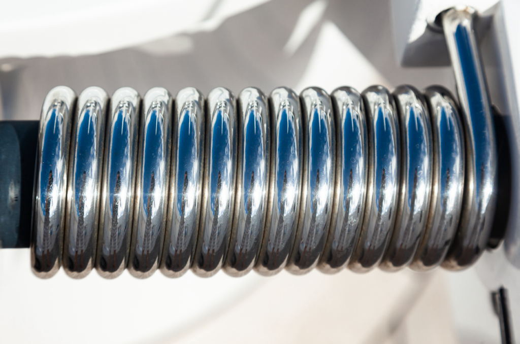Stainless steel spring on a garage door hinge. 